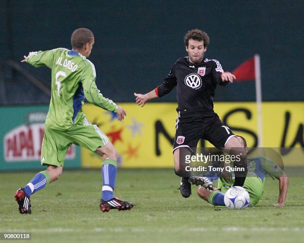 Ben Olsen of D.C. United is caught between Peter Vagenas and Osvaldo Alonso of Seattle Sounders FC during an MLS match at RFK Stadium on September...
