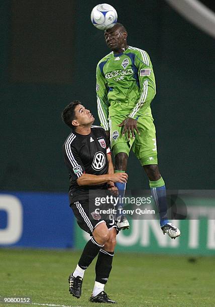 Jaime Moreno of D.C. United is beaten to a high ball by Jhon Kennedy Hurtado of Seattle Sounders FC during an MLS match at RFK Stadium on September...