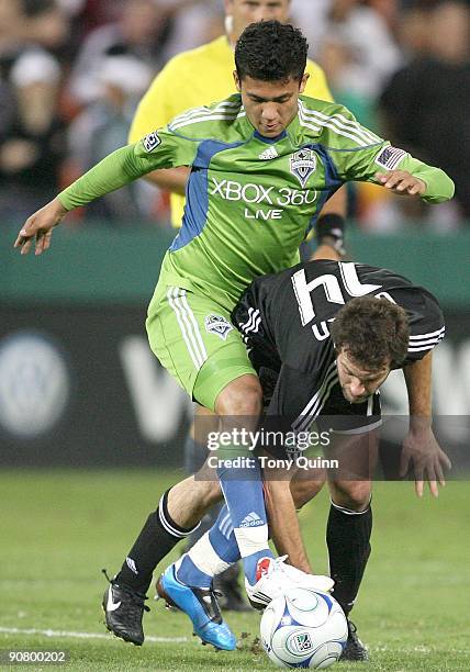 Ben Olsen of D.C. United battles with Fredy Montero of Seattle Sounders FC during an MLS match at RFK Stadium on September 12, 2009 in Washington,...