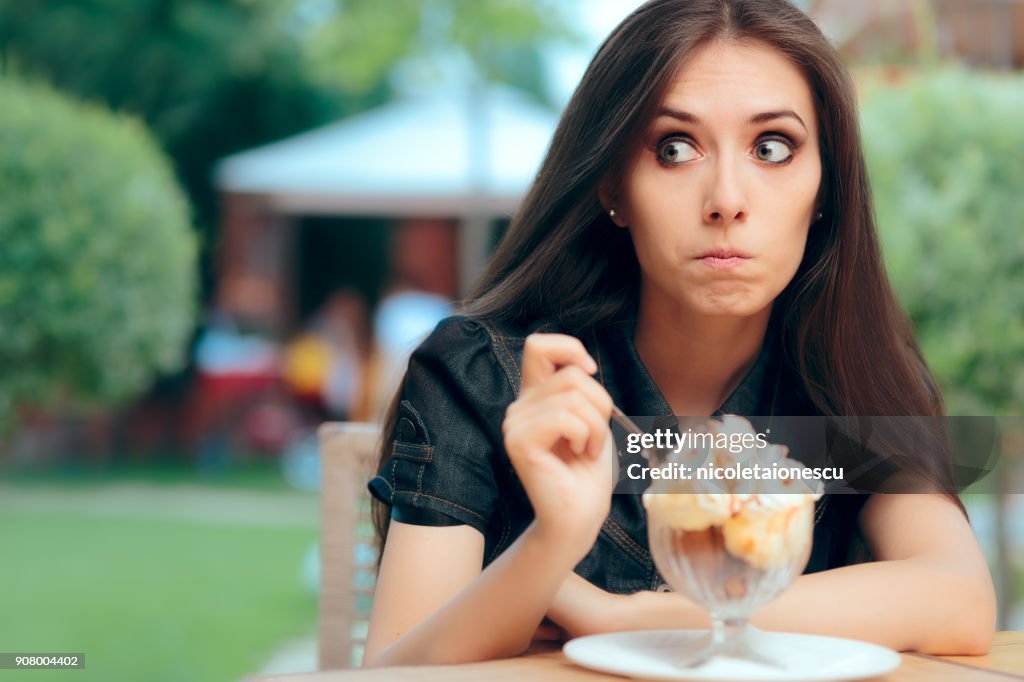 Girl Heisting to a Eat High Calorie Ice Cream Dessert
