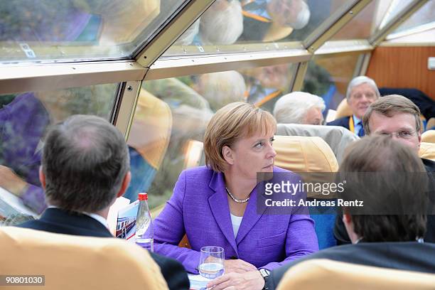 German Chancellor Angela Merkel of the Christian Democratic Union takes a seat during her election campaign rally in the historic 'Rheingold' train...