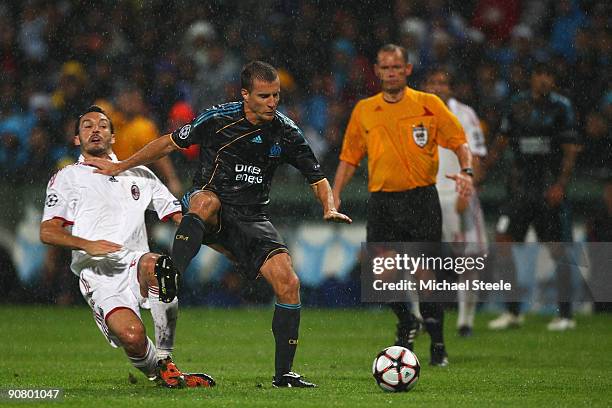 Benoit Cheyrou of Marseille holds off Gianluca Zambrotta of Milan during the UEFA Champions League Group C match between Marseille and AC Milan at...