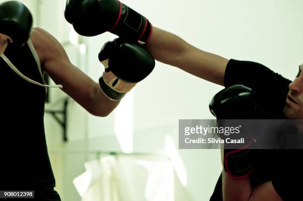 a man and a woman during a kickboxing combat training - silvia casali stock-fotos und bilder