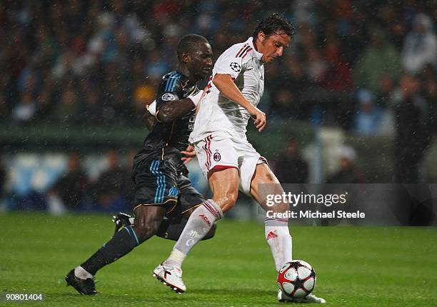 Massimo Oddo of Milan shields the ball from Mamadou Niang during the UEFA Champions League Group C match between Marseille and AC Milan at the Stade...