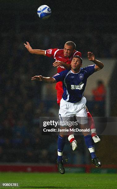 Jon Walters of Ipswich Town competes in the air with Joel Lynch of Nottingham Forest during the Coca Cola Championship match between Ipswich Town and...