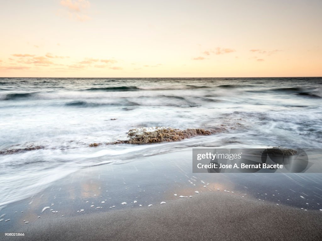Coast line with cliffs and beaches with water waves in movement. Cabo de Gata - Nijar Natural Park, Beach of the white crag, Isleta of the Moor, Biosphere Reserve, Almeria, Andalusia, Spain.