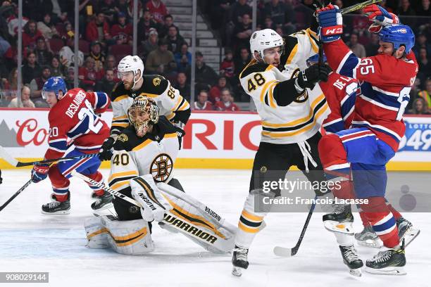 Andrew Shaw of the Montreal Canadiens fight for the puck against Matt Grzelcyk of the Boston Bruins in the NHL game at the Bell Centre on January 13,...