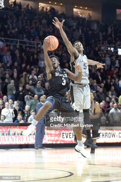 Kamar Baldwin of the Butler Bulldogs drives to basket past Rodney Bullock of the Providence Friars during a college basketball game at Duncan' Donut...