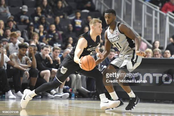 Kelan Martin of the Butler Bulldogs dribbles a round Alpha Diallo of the Providence Friars during a college basketball game at Duncan' Donut Center...