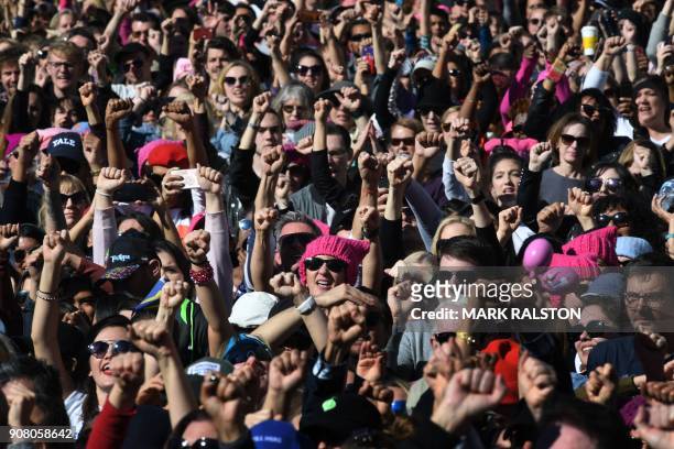 Protesters who are part of a 500,000 strong crowd, raise their fists during the Women's Rally on the one-year anniversary of the first Women's March,...