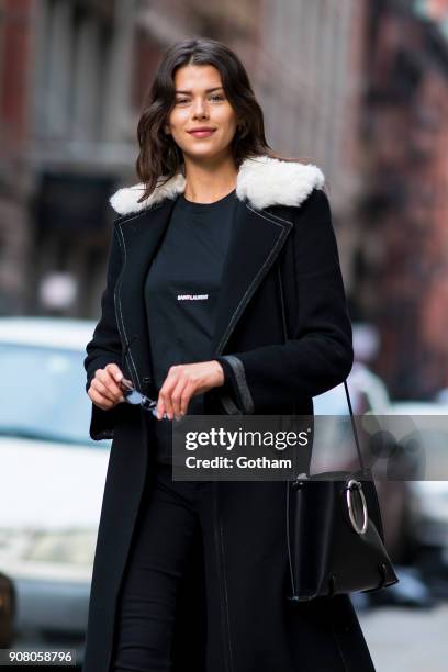 Georgia Fowler is seen wearing a Helmut Lang coat, Saint Laurent shirt and boots with Roberi & Fraud glasses in SoHo on January 20, 2018 in New York...