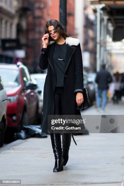 Georgia Fowler is seen wearing a Helmut Lang coat, Saint Laurent shirt and boots with Roberi & Fraud glasses in SoHo on January 20, 2018 in New York...