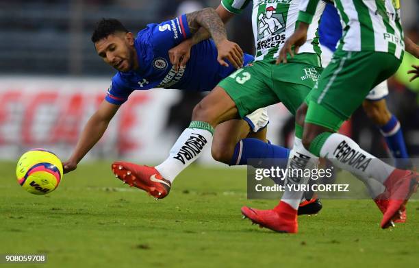 Cruz Azul's midfielder Walter Montoya falls as he vies for the ball with Leon's midfielder Alexander Mejia during their Mexican Clausura football...