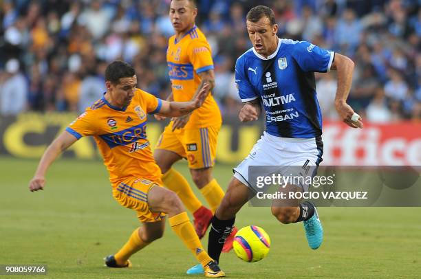 Diego Novaretti of Queretaro is marked by Jesus Duenas of Tigres during the Mexican Clausura football tournament match at La Corregidora stadium in...