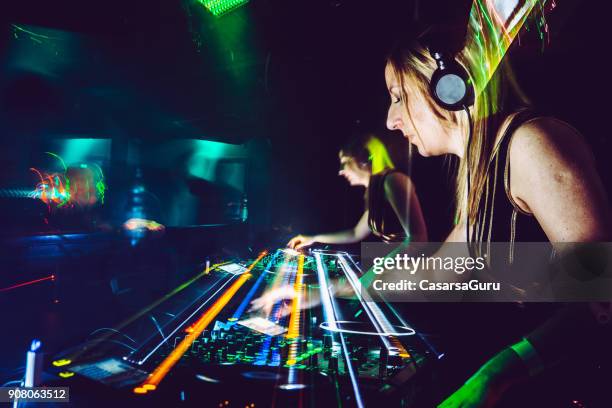 female dj artist mixing music at techno party - synthesizer stock pictures, royalty-free photos & images