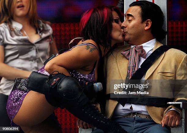 Singer Alejandra Guzman kisses TV host Adal Ramones during the concerts of the 199th anniversary of the Mexican Independence at Zocalo on September...