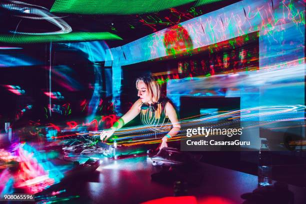 young female dj mixing music in a nightclub - dj imagens e fotografias de stock