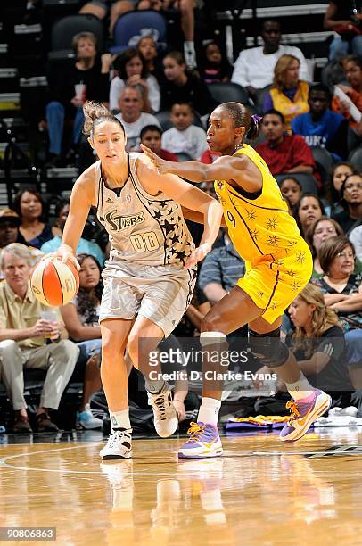 Ruth Riley of the San Antonio Silver Stars drives the ball around Lisa Leslie of the Los Angeles Sparks during the WNBA game on September 5, 2009 at...