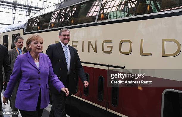 German Chancellor Angela Merkel and German Defence Minister Franz Josef Jung of the Christian Democratic Union walk beside the train during an...