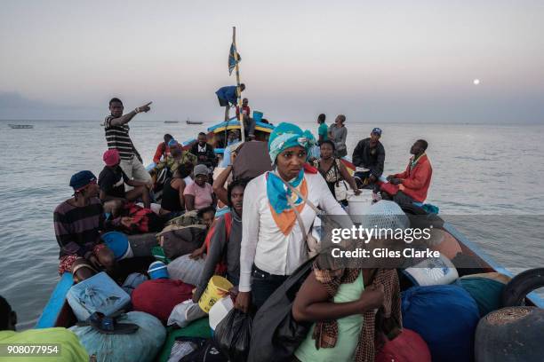 Madam Sara's pack themselves and goods onto wooden cargo boats that sail back and forward from Merigot to Anse-An-Pitres on the Dominican Republic...