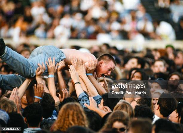 Crowd surfing at a Cure concert, Robert Smith, lead singer, guitarist, multi instrumentalist, lyricist, principal songwriter and only consistent...