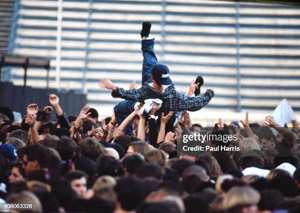 Crowd surfing at a Cure concert, Robert Smith, lead singer, guitarist, multi instrumentalist, lyricist, principal songwriter and only consistent...