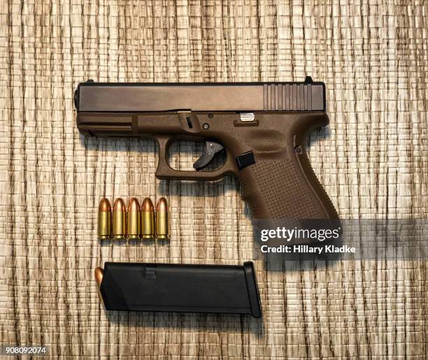 handgun with 9mm bullets - 9mm pistol stock-fotos und bilder