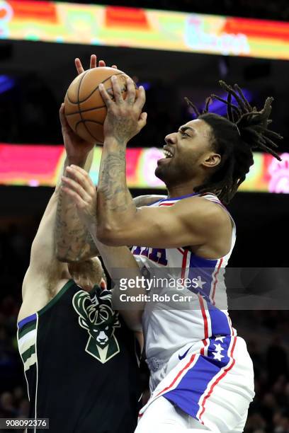 Matthew Dellavedova of the Milwaukee Bucks fouls James Young of the Philadelphia 76ers in the first half at Wells Fargo Center on January 20, 2018 in...