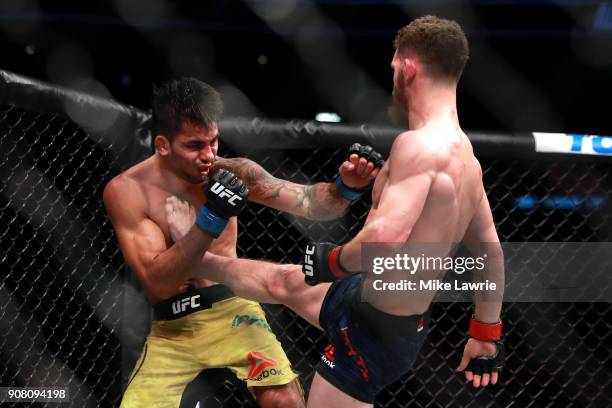 Dustin Ortiz kicks Alexandre Pantoja in their Flyweight fight during UFC 220 at TD Garden on January 20, 2018 in Boston, Massachusetts.