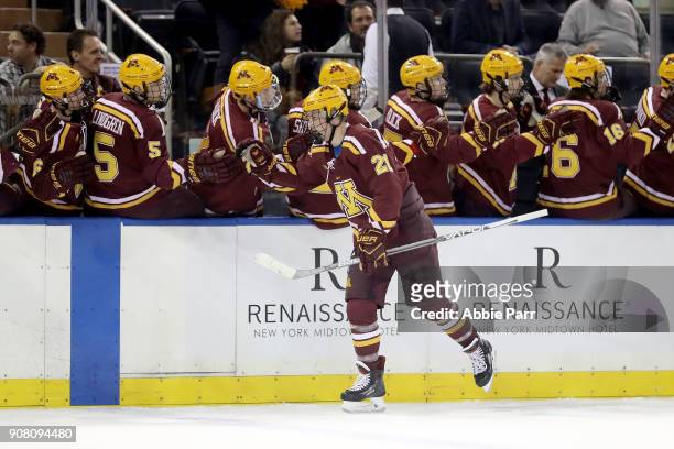 Casey Mittelstadt of the Minnesota Golden Gophers celebrates with teammates after scoring a goal in the first period against the Michigan State...