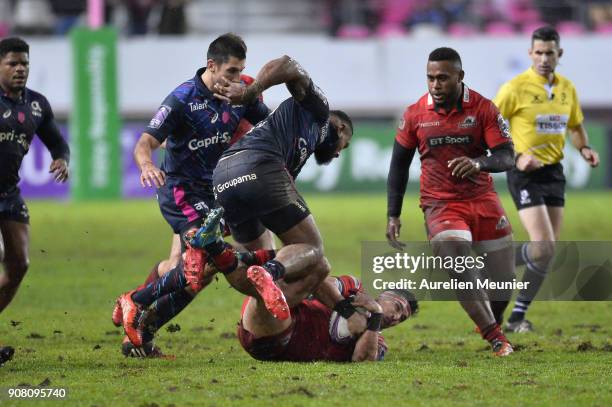 Damian Hoyland of Edinburgh is tackled by Waisea Nayacalevu of Stade Francais during the European Rugby Challenge Cup match between Stade Francais...