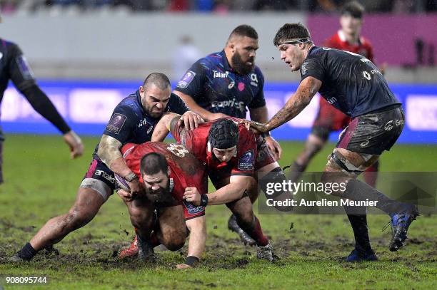 Cornell Du Preez of Edinburgh is tackled by Zurabi Zhvania of Stade Francais during the European Rugby Challenge Cup match between Stade Francais and...