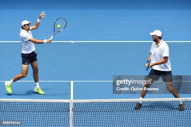 Jeremy Chardy of France and Fabrice Santoro of France talk tactics in their third round men's doubles match against Bob Bryan of the United States...
