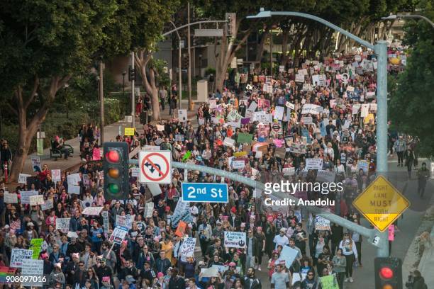 People hold banners as they participate in the Women's March rally on January 20, 2018 in Los Angeles, California, United States.