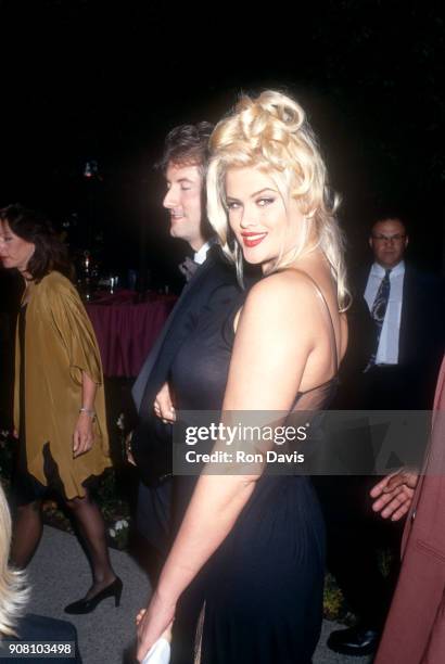 American model and actress Anna Nicole Smith and guest arrive for the 'Naked Gun 33 1/3: The Final Insult' Hollywood Premiere on March 16, 1994 at...