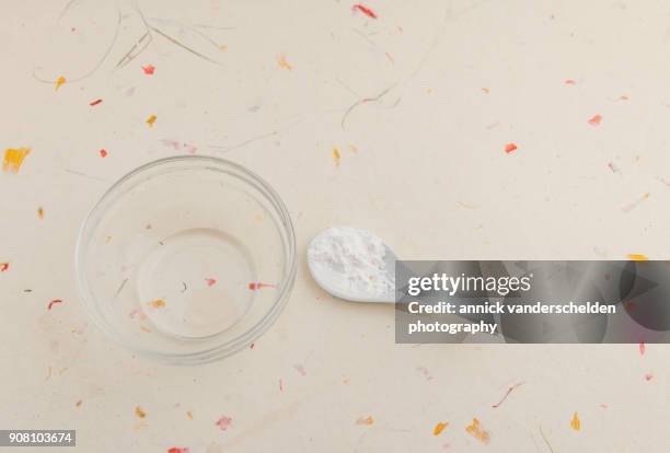 dissolving cornstarch in tablespoon of water. - cornstarch stock pictures, royalty-free photos & images