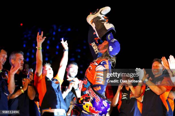 Toby Price of Australia and Red Bull KTM Team drinks champagne from his race boot as he celebrates on the podium after stage fourteen of the 2018...