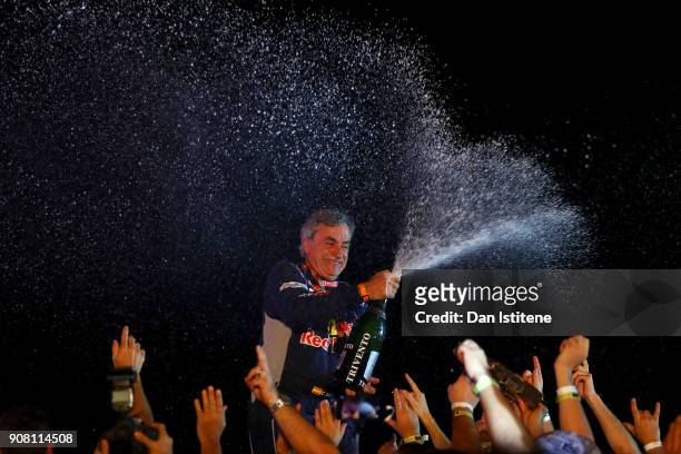 Carlos Sainz of Spain and Peugeot Total celebrates victory with their team on the podium after stage fourteen of the 2018 Dakar Rally, a loop stage...