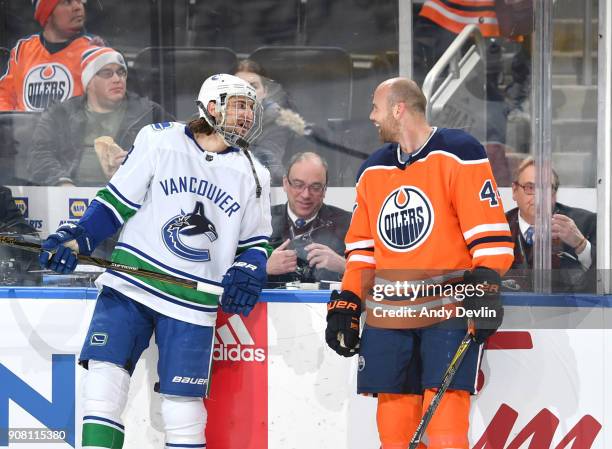 Zack Kassian of the Edmonton Oilers exchanges words with Christopher Tanev of the Vancouver Canucks on January 20, 2017 at Rogers Place in Edmonton,...