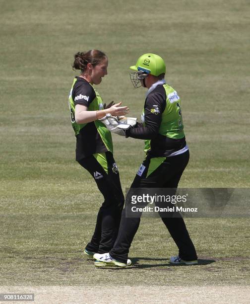 Thunder Rene Farrell and Rachel Priest celebrate after taking the wicket of Strikers Sophie Devine during the Women's Big Bash League match between...