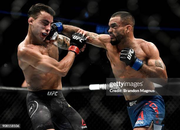 Rob Font punches Thomas Almeida of Brazil in their bantamweight bout during the UFC 220 event at TD Garden on January 20, 2018 in Boston,...