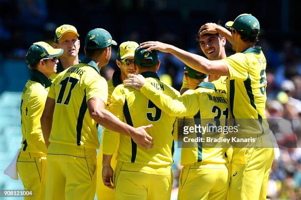Pat Cummins of Australia is congratulated by team mates after taking the wicket of Jason Roy of England during game three of the One Day...