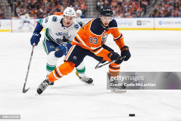 Matthew Benning of the Edmonton Oilers is pursued by Markus Granlund of the Vancouver Canucks at Rogers Place on January 20, 2018 in Edmonton, Canada.