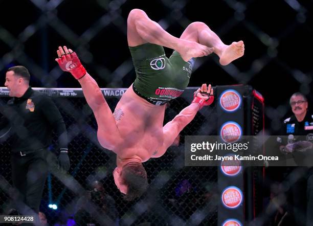 Michael Chandler Jr does a backflip in the cage as he celebrates after defeating Goiti Yamauchi in their Lightweight fight at Bellator 192 at The...