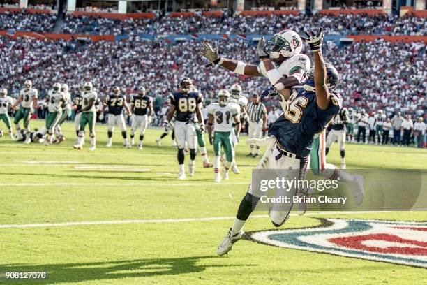 Players fight for the ball as the Miami Dolphins defeat the San Diego Chargers 12-9 at Joe Robbie Stadium, in Miami, FL.