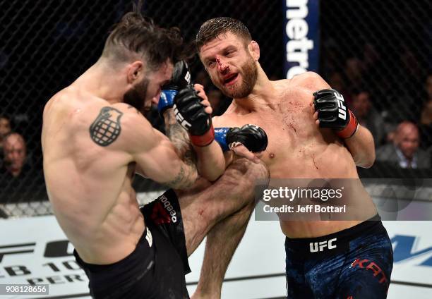 Calvin Kattar punches Shane Burgos in their featherweight bout during the UFC 220 event at TD Garden on January 20, 2018 in Boston, Massachusetts.