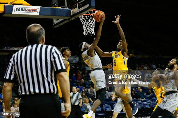 Toledo Rockets guard Marreon Jackson goes in for a layup against Kent State Golden Flashes forward Danny Pippen during the first half of a regular...