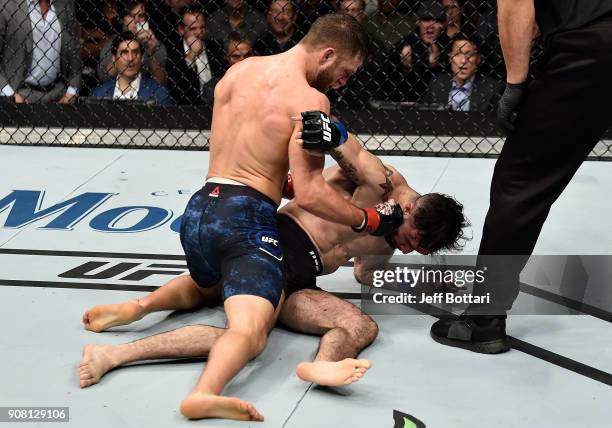 Calvin Kattar punches Shane Burgos in their featherweight bout during the UFC 220 event at TD Garden on January 20, 2018 in Boston, Massachusetts.