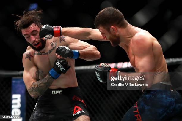 Calvin Kattar throws a punch against Shane Burgos in their Featherweight fight during UFC 220 at TD Garden on January 20, 2018 in Boston,...