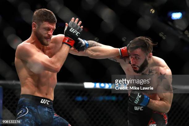 Calvin Kattar throws a punch against Shane Burgos in their Featherweight fight during UFC 220 at TD Garden on January 20, 2018 in Boston,...